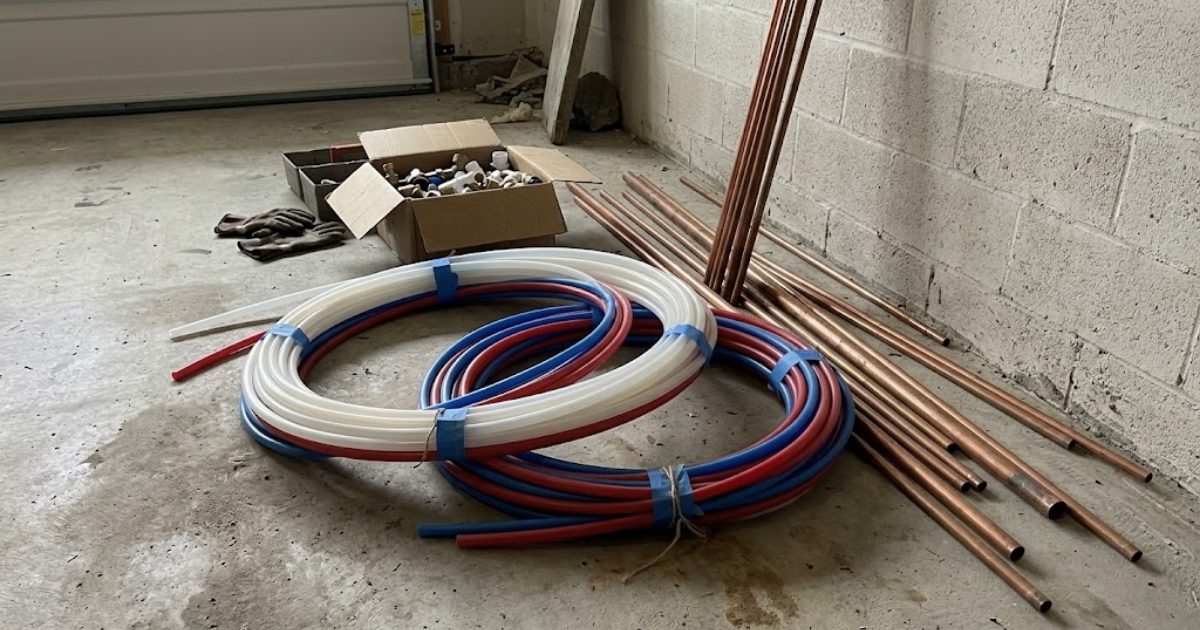 New copper and PEX pipe staged for a repipe job